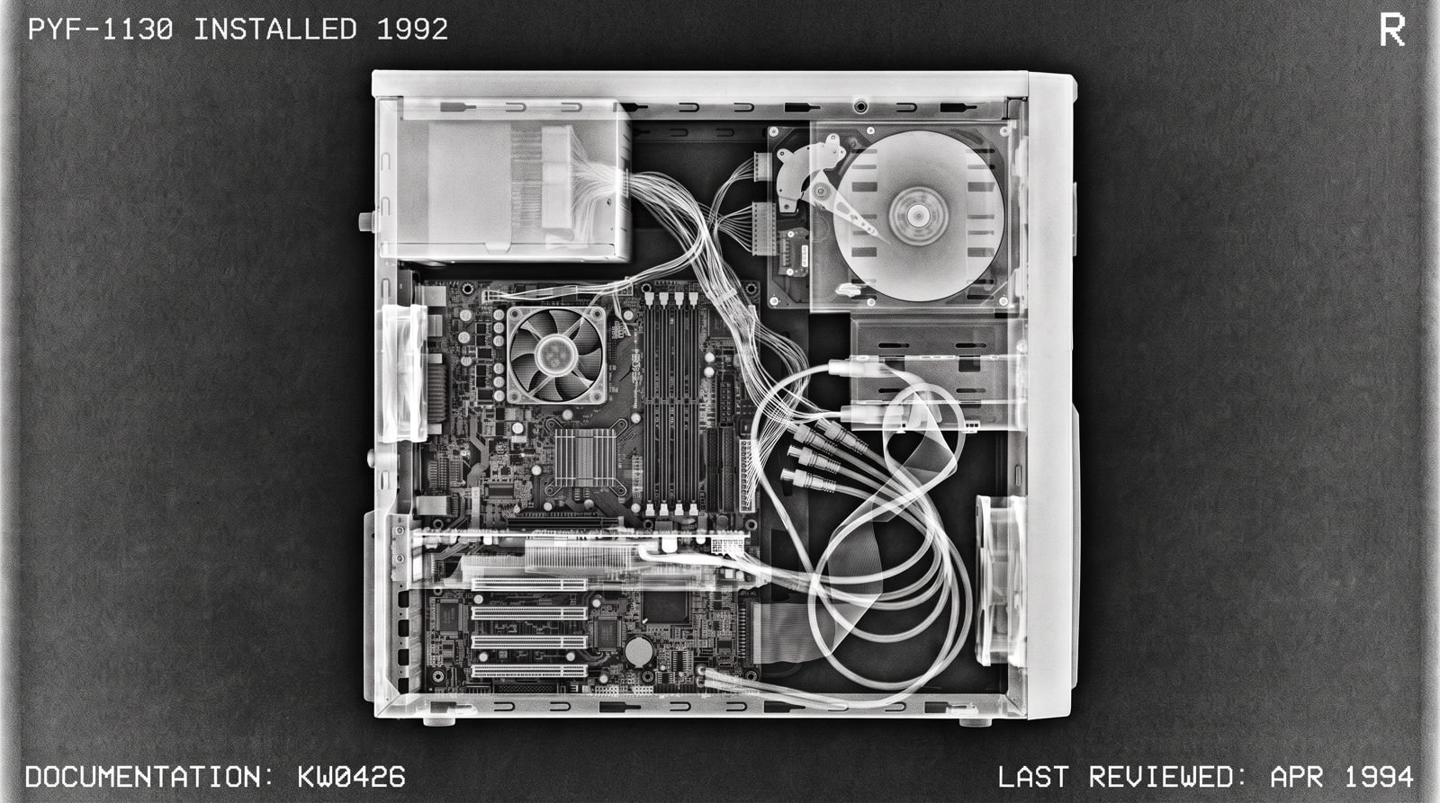 X-ray view inside an old office computer, labelled PYF-1130, installed 1992, documentation KW0426, last reviewed April 1994